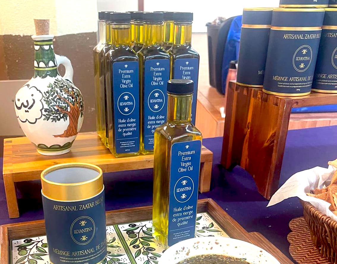 Levantina premium olive oil bottles and artisanal zaatar tins arranged on a display table
